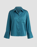 Teal shirt on a light gray background